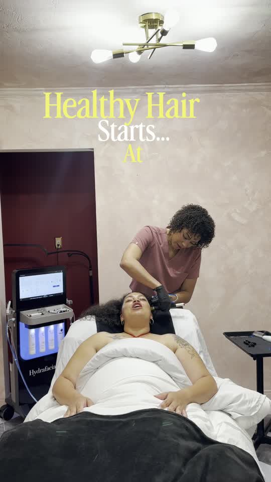 A client reclined at the treatment bed while the scalp is worked through in sections